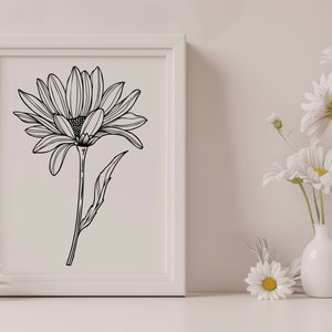 May include: A black and white line drawing of a daisy in a white frame. The frame is on a white surface with white daisies in vases.
