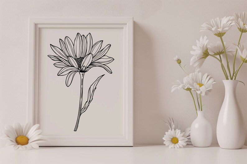 May include: A black and white line drawing of a daisy in a white frame. The frame is on a white surface with white daisies in vases.