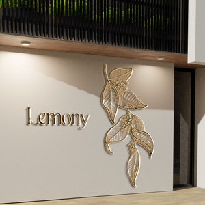 Pu&ograve; includere: Una vetrina bianca con un cartello dorato che recita "Lemony" e un disegno di foglie dorate sul muro.