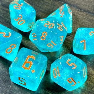 Trident DnD Dice Set for Dungeons and Dragons | D20 TT RPG Polyhedral Dice Set | Aqua Green iridescent dice with an Orange font!