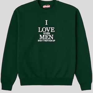 A dark green sweatshirt with white text printed on it.
