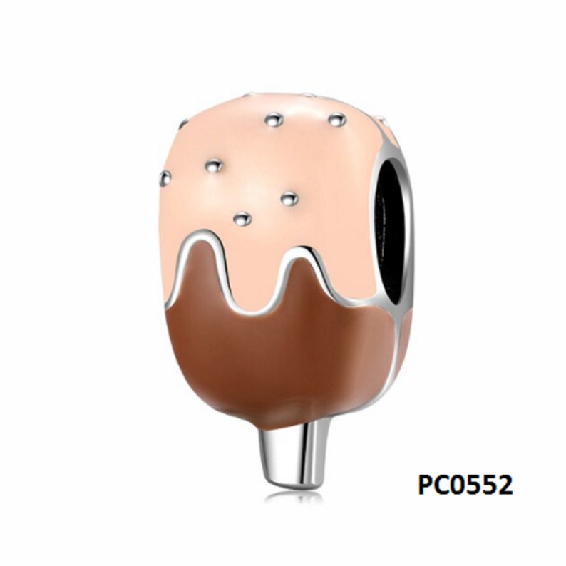 May include: A silver charm in the shape of an ice cream cone with brown and pink enamel. The ice cream is topped with white sprinkles.