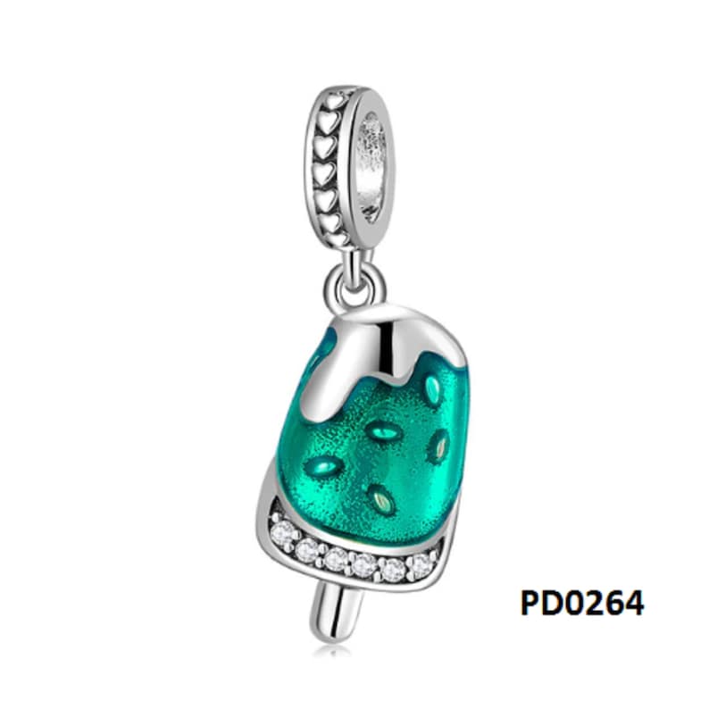 May include: Silver charm with a green popsicle design. The popsicle has a white drip and is decorated with clear crystals. The charm has a heart-shaped bail.