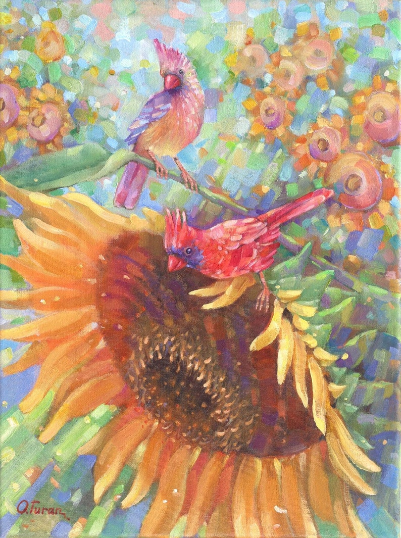 May include: A painting of two red cardinals perched on a branch in front of a large sunflower. The sunflower is in bloom and has a bright yellow center. The cardinals are red with black eyes and beaks. The background is a blur of green and blue.