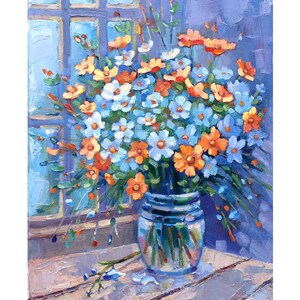 May include: A bouquet of blue and orange wildflowers in a clear glass vase on a wooden table. The flowers are arranged in a loose, natural style, and the vase is simple and elegant.