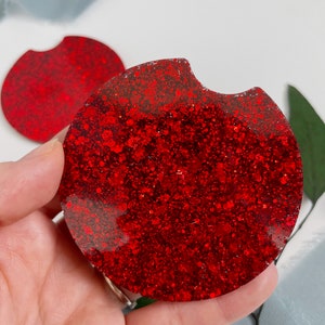 May include: Red glitter car coaster with a cut-out for a cup holder.