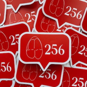 May include: A pile of red stickers with a white outline. Each sticker features a pair of red slippers and the number 256.