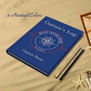 May include: A blue notebook with a compass design and the text "Captain's Log" and "Boat Name Here". The notebook has red and white stripes on the cover.