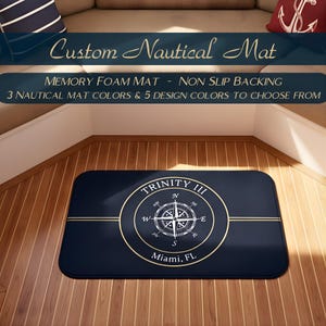 May include: A navy blue rectangular nautical mat with a compass design and the text "TRINITY III Miami, FL". The mat has a memory foam core and non-slip backing. The text "Custom Nautical Mat" is at the top.