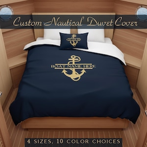 May include: Navy blue duvet cover set featuring a gold anchor design and the text "BOAT NAME HERE". Includes a matching pillow with an anchor emblem. The text "Custom Nautical Duvet Cover" is at the top. The text "4 SIZES, 10 COLOR CHOICES" is at the bottom.