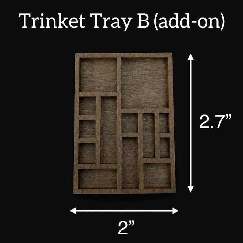 May include: A wooden trinket tray with multiple compartments, measuring 2 inches wide and 2.7 inches tall. The tray is a dark brown color and has a rectangular shape with various sized square and rectangular compartments.