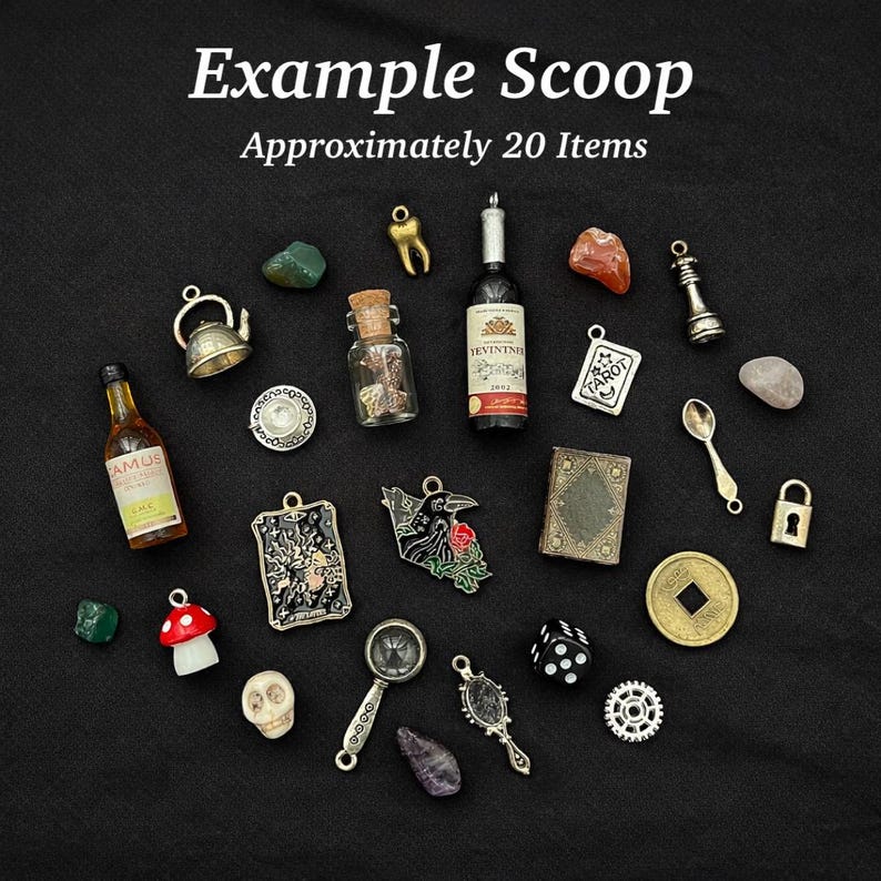 May include: A collection of approximately 20 miniature charms and trinkets including a bottle of Camus, a wine bottle, a teapot, a mushroom, a skull, a magnifying glass, a die, a padlock, a tarot card, a book, a coin, and various stones.