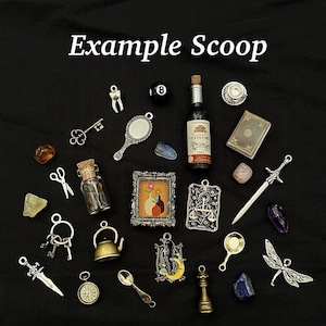 May include: A collection of miniature charms and trinkets, including a tiny wine bottle, a mirror, a sword, and a framed picture. The items are arranged on a black surface, with the text "Example Scoop" at the top.