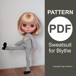 May include: A doll wearing a gray sweatsuit with a yellow heart design on the chest. The doll has blonde hair and black shoes. The image includes the text "PATTERN PDF Sweatsuit for Blythe".