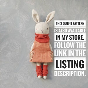 May include: A handmade fabric bunny doll wearing a coral orange dress with floral print pockets and matching leg warmers. The doll has a white fabric body and a red fabric turtleneck. The image includes the text "THIS OUTFIT PATTERN IS ALSO AVAILABLE IN MY STORE. FOLLOW THE LINK IN THE LISTING DESCRIPTION."