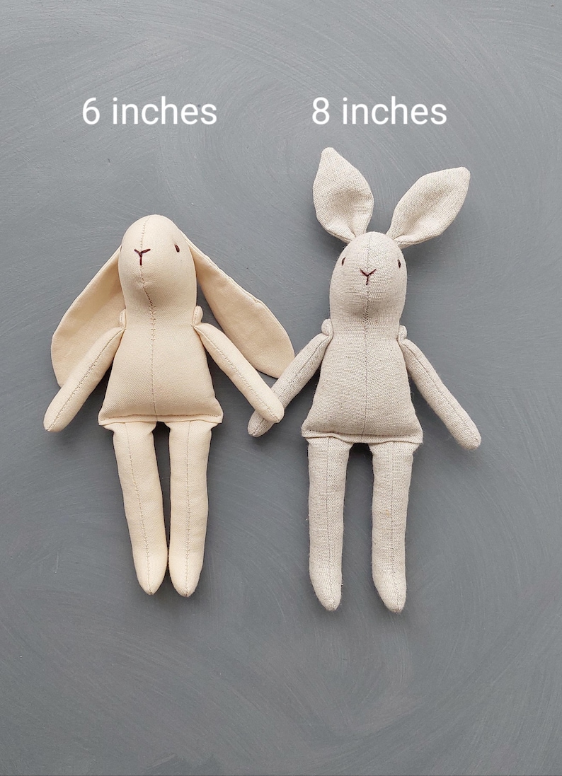 May include: Two beige linen bunny plushes, one 6 inches tall and the other 8 inches tall.