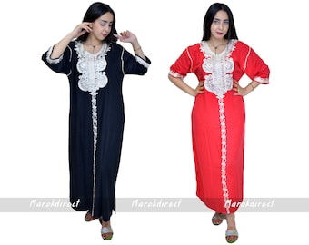 May include: Two women wearing long, loose-fitting dresses with white embroidery. The dress on the left is black and the dress on the right is red.