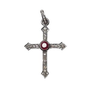 May include: A silver cross pendant with a red ruby gemstone in the center and small diamonds around the edges.