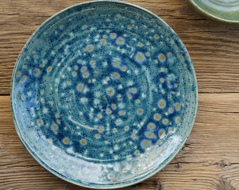 Beautiful hand-made ceramic plate in a modern design as decoration or for fruit, etc