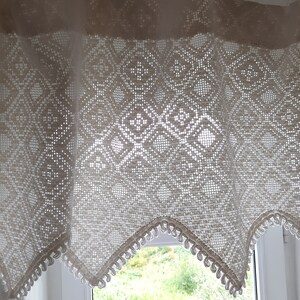 May include: White crocheted valance with a diamond pattern and scalloped edges. The valance has a delicate, lacy look and would add a touch of elegance to any window.