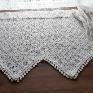 May include: White crocheted valance with a diamond pattern and a scalloped edge with tassels.