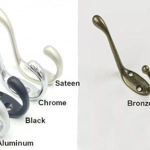 May include: Five double-pronged hooks in different finishes: aluminum, black, chrome, sateen, and bronze. The hooks are all the same shape and size.