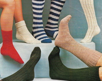 May include: Five pairs of knitted socks in different colors and patterns. The socks are displayed on a white surface. The socks are red, white, blue, black, and beige.