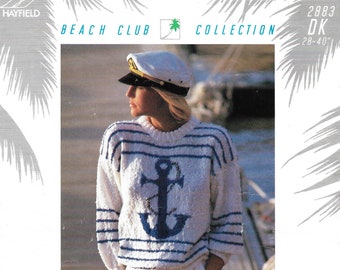 May include: A white sweater with blue stripes and an anchor design. The sweater is worn by a woman with a white sailor hat. The text "Hawaii DK" is written in green letters at the bottom of the image.