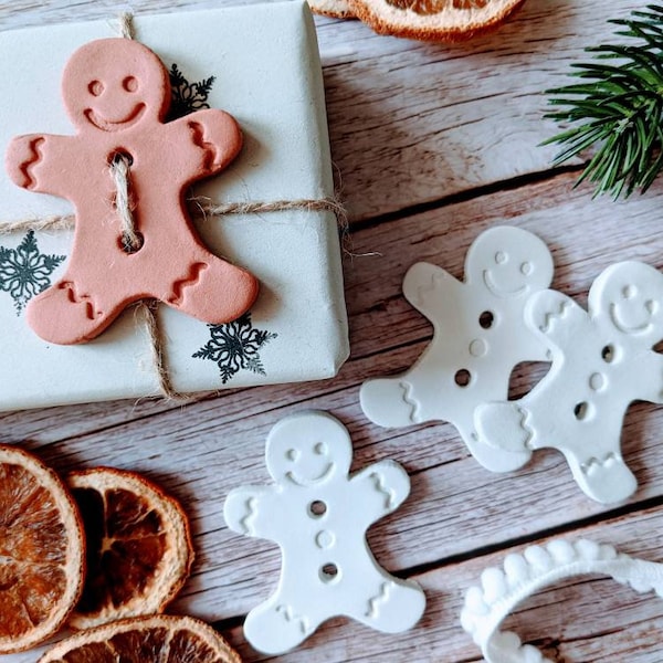 Gingerbread man gift wrap buttons. Clay present tags. Add to Christmas wrapping for a festive touch. Set of 6 White, terracotta or 3 of each