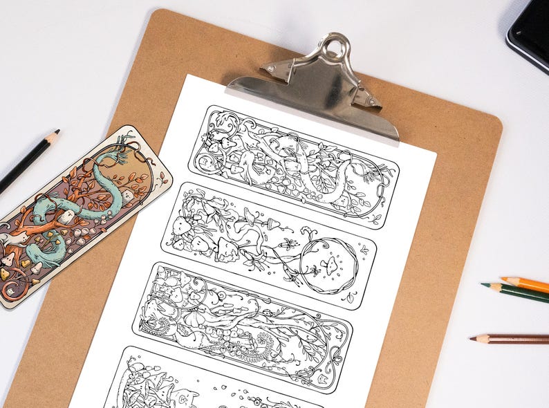 May include: A selection of illustrated bookmarks and designs. The bookmarks feature detailed black and white line art of fantastical creatures and nature elements. Pencils and a clipboard are also visible.