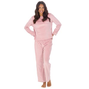 May include: A pink velour pajama set with long sleeves and pants. The top has a white embroidered name "Adelle" on the front.