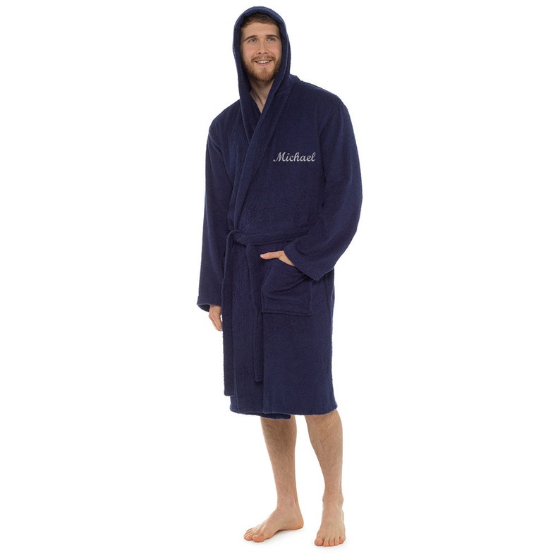 May include: A navy blue hooded robe with a white embroidered name "Michael" on the front.