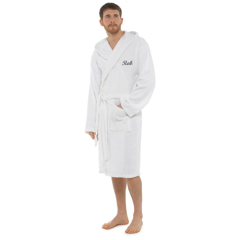 May include: White hooded bathrobe with a black embroidered name "Rob" on the front.