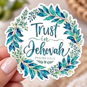 May include: A circular sticker featuring a watercolor wreath of teal and blue leaves surrounding the text Trust in Jehovah and Psalms 115:11 in dark blue script and print. A small green heart icon is positioned below the scripture reference.