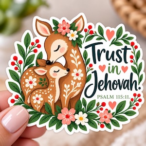 May include: A die-cut sticker featuring a brown deer and fawn surrounded by green leaves, red berries, and pink and white flowers. The text reads Trust in Jehovah and Psalm 115:11, accompanied by small pink hearts, all set against a white background.