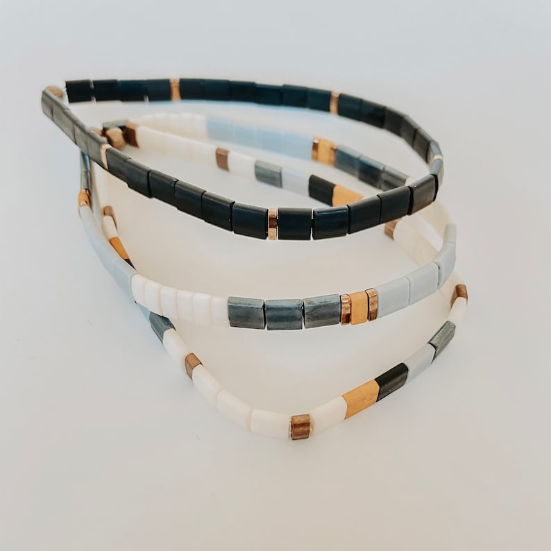 Stack of 3 Tila bead bracelets made of colorful square glass beads and elastic.