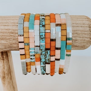 Tila bead bracelets made of colorful square glass beads and elastic.