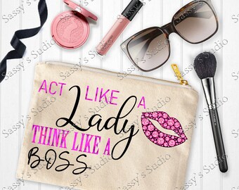 May include: A beige canvas makeup bag with the text "Act Like A Lady Think Like A Boss" in pink and black lettering. A pink sparkly lip print is on the right side of the bag.
