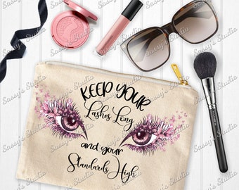 May include: A beige canvas makeup bag with a zip closure. The bag features a graphic of two eyes with pink eyelashes and flowers. The text "Keep Your Lashes Long and Your Standards High" is printed on the bag.