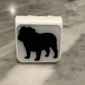 May include: White night light with a black silhouette of a bulldog.