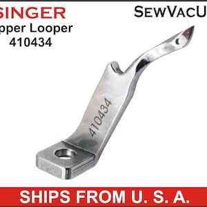 May include: Singer Upper Looper 410434 sewing machine part, a silver metal hook with a small hole at the top and the number 410434 engraved on the side.