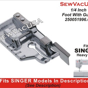May include: A silver 1/4 inch sewing foot with a guide for Singer heavy duty sewing machines. The foot is designed for precise stitching and has a clear guide for consistent seam allowances. The part number is 250051996.01.