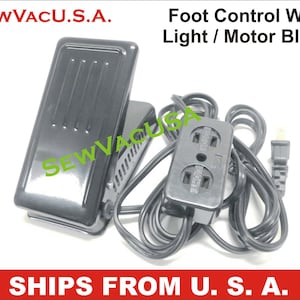 May include: Black foot pedal with a black power cord and a black power adapter with two outlets. The foot pedal is labeled "SEWVACU.S.A." and the power adapter is labeled "SEWVAGL". The text "Foot Control With Light / Motor Block" is above the image. The text "SHIPS FROM U. S. A." is below the image.