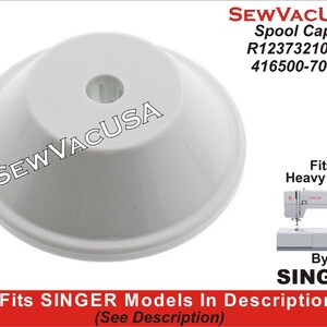 May include: White plastic spool cap for a Singer sewing machine. The cap is labeled "Spool Cap R12373210B 416500-701" and "Fits Heavy Duty By SINGER".