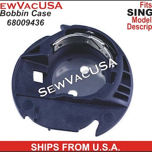 May include: A black plastic bobbin case for a Singer sewing machine. The case has a metal hook and a series of slots on the side. The case is labeled "SEWVACUSA Bobbin Case 68009436".
