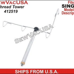 May include: A silver thread tower with three hooks for holding spools of thread. The tower is designed to fit Singer sewing machines. The tower is made of metal and has a black plastic knob at the top.