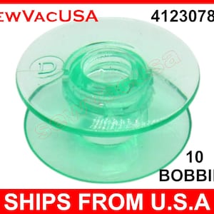 May include: A transparent green sewing machine bobbin with a central spool and two circular flanges. The text "10 BOBBINS" is visible. The product is labeled "SEW VAC USA" and "4123078-G".