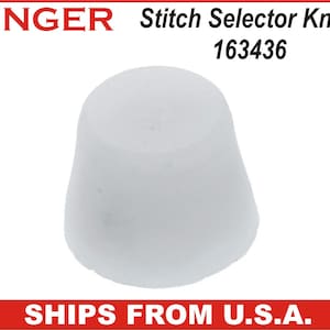 May include: A white Singer Stitch Selector Knob, model 163436. The knob is a solid, rounded shape, likely a replacement part for a sewing machine. The Singer logo is visible in red at the top of the image.