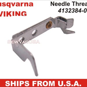 May include: A silver metal needle threader for a sewing machine. The threader has a small loop at the end and a small hole in the middle. The part number 4132384-02 is printed on the image. The text "Husqvarna VIKING" is printed at the top of the image.
