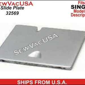 May include: A silver sewing machine slide plate with the text "SEWVACUSA" printed on it. The part number 32569 is printed below the text. The slide plate is designed to fit Singer sewing machines.